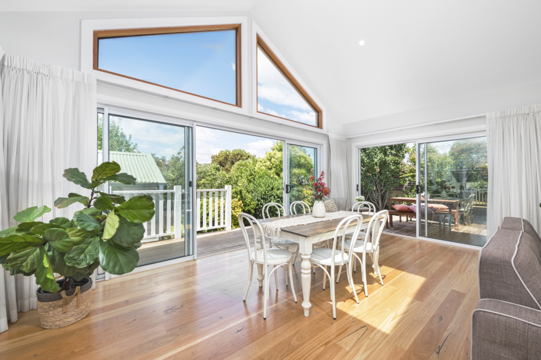 Queanbeyan Cottage dining area with raked ceiling and garden view